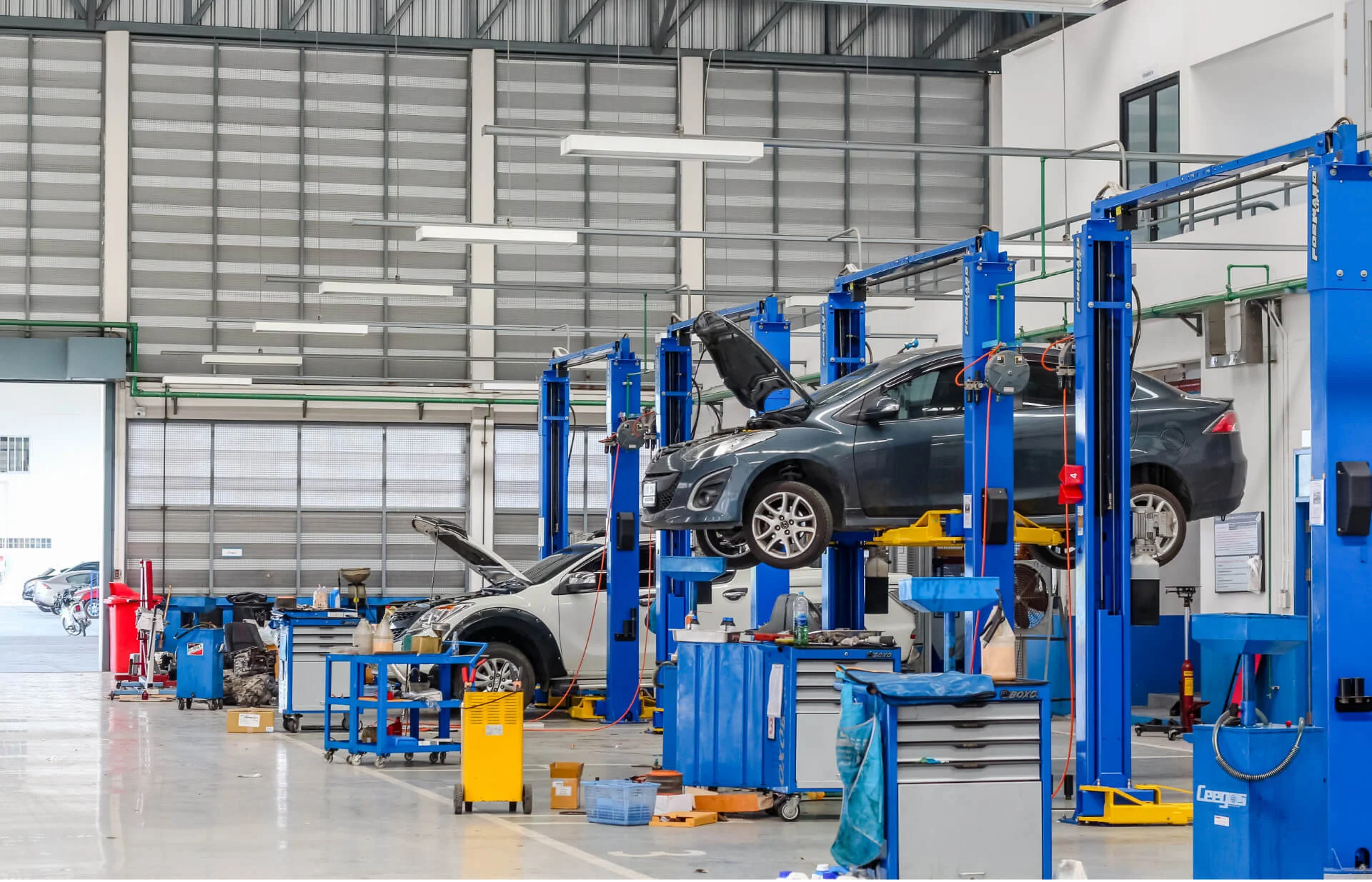 Envision Ford service bay with vehicles on lifts being serviced and upfitted
