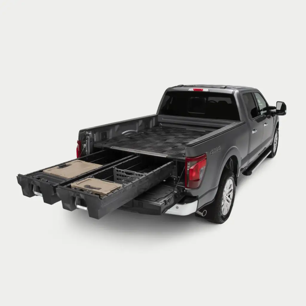 Gray Ford F-150 with a DECKED bed drawer system, both drawers pulled out over the open tailgate