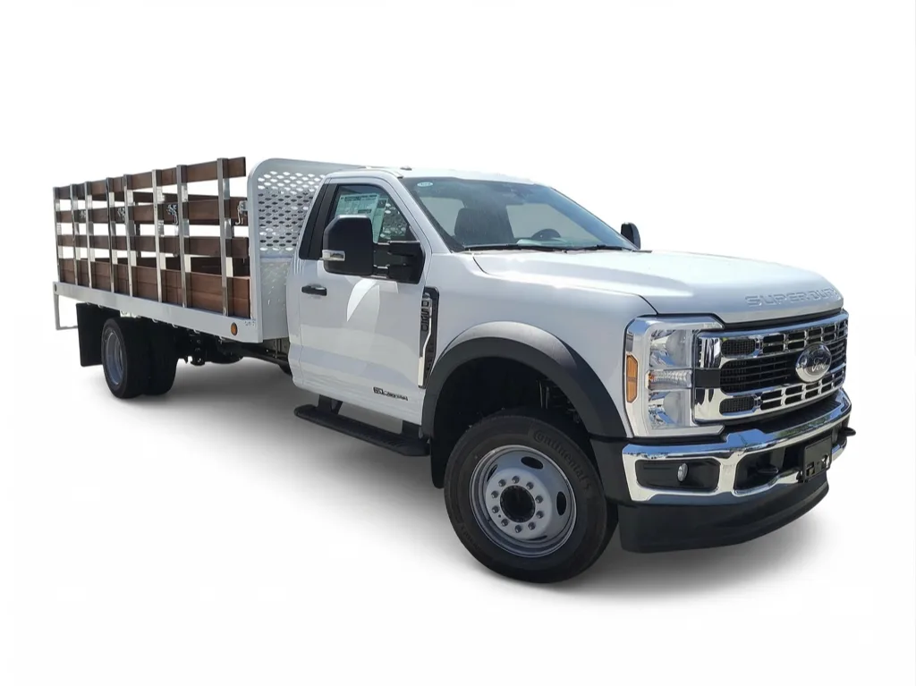 Ford F-550 with a wood stake bed body and perforated steel headache rack